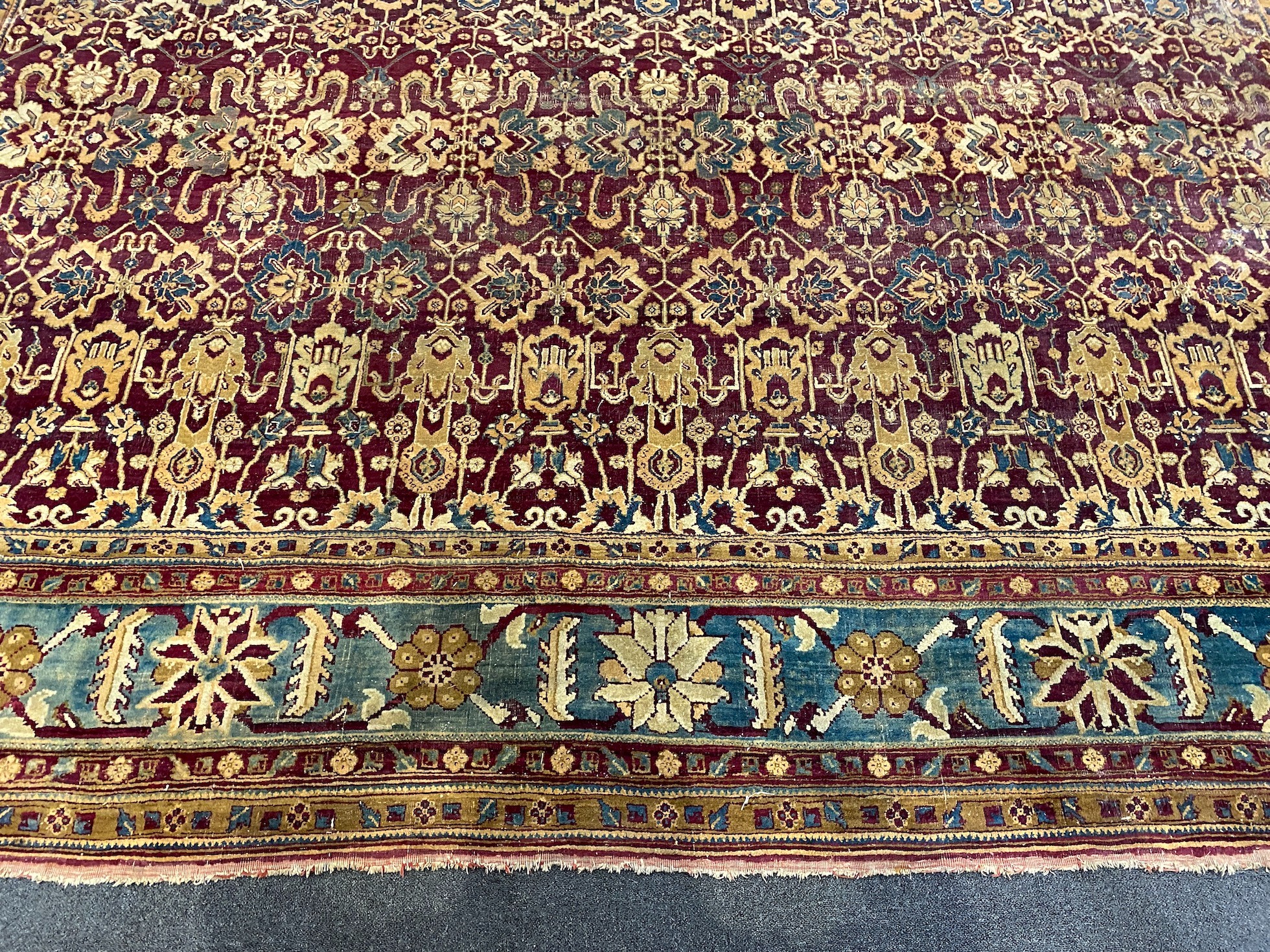 A large Sarouk purple ground carpet, approx. 20ft x 12ft. (cut in one area)